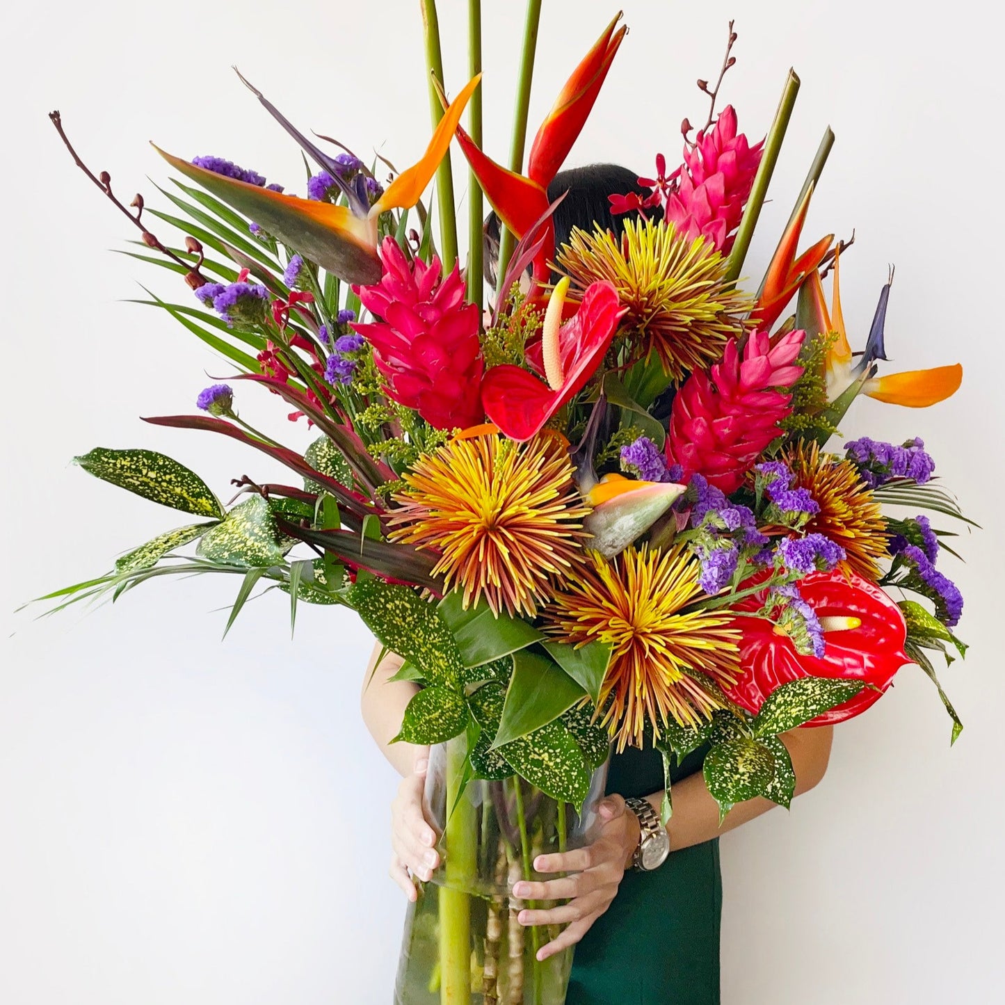 A bold burst of fiery elegance, this exotic arrangement features anthuriums, lobster claws, safina, and heliconia in intense red and orange tones. With striking shapes and vibrant hues, it’s perfect for making powerful statements and celebrating life with flair.