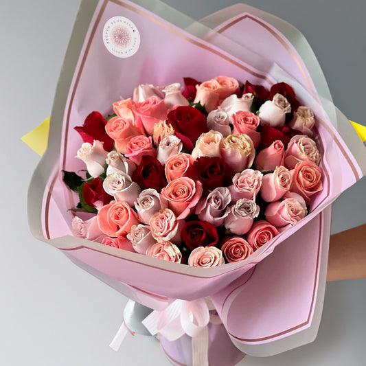 A stunning medley of white, red, and peach roses, this bouquet of 50 exquisite blooms symbolizes love, purity, and warmth. The soft peach tones blend beautifully with the bold red and serene white, creating a harmonious and elegant floral masterpiece perfect for any occasion.