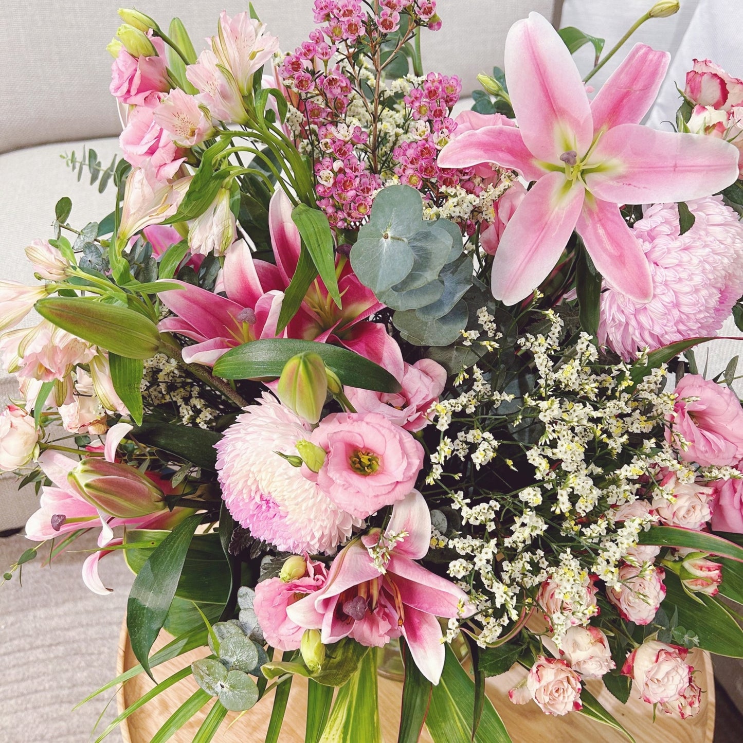 A romantic arrangement in soft pink tones, featuring lilies, roses, carnations, eustoma (lisianthus), orchids, and wax flowers. Delicate and dreamy, this bouquet captures the essence of tenderness and grace—perfect for celebrating love, beauty, and meaningful moments.