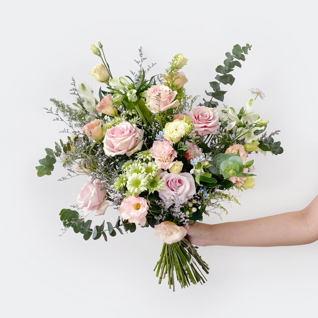 A vibrant celebration of color and charm, this bouquet features a delightful mix of roses, carnations, eustoma (lisianthus), daisies, and orchids. Each bloom brings its own unique texture and hue, creating a joyful, heartwarming arrangement perfect for any special moment.