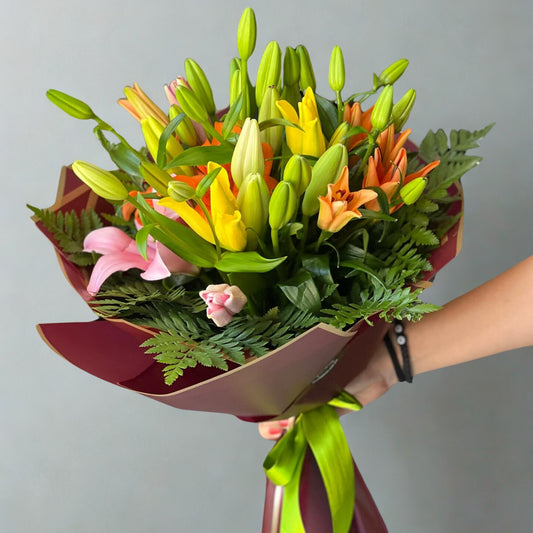 A stunning bunch of lilies, symbolizing purity, beauty, and grace. The elegant blooms, with their soft petals and gentle fragrance, create a refined bouquet that adds sophistication and charm to any occasion