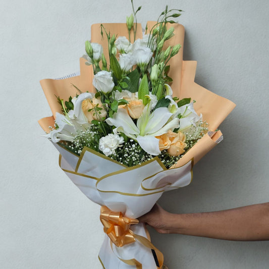 An effortlessly graceful bouquet that combines white lilies, creamy white eustoma, and blush-toned jumeria roses — perfect for someone who loves understated luxury and poetic beauty.

