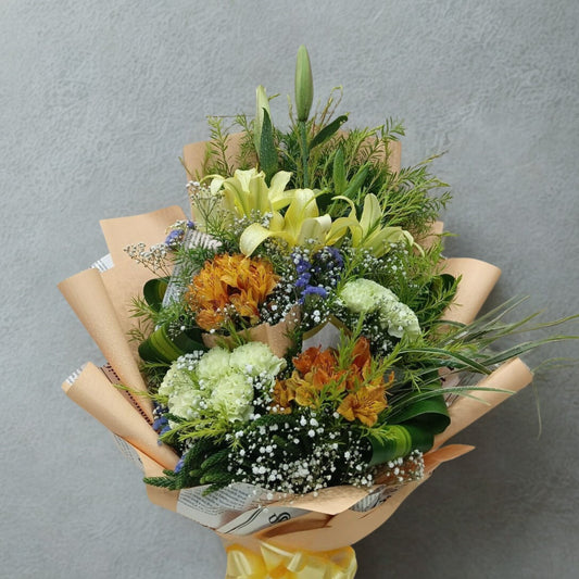 Bouquet of flowers wrapped in brown paper against a gray background